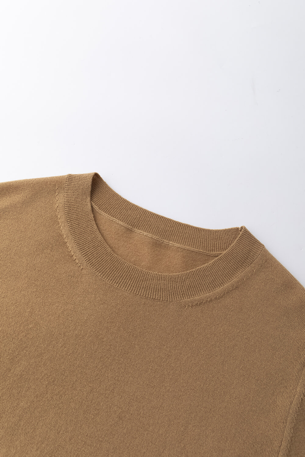 the shoulder and crew neck of pure merino wool jumper